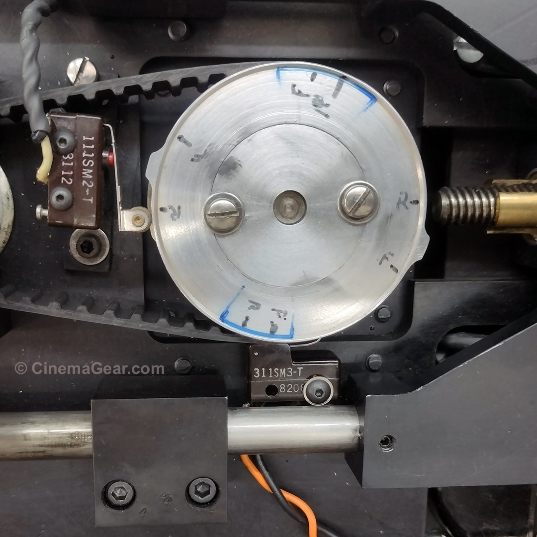 A closeup of the movement drive sprocket in the Dykstraflex camera, showing the later addition of frame position timing cams and microswitches