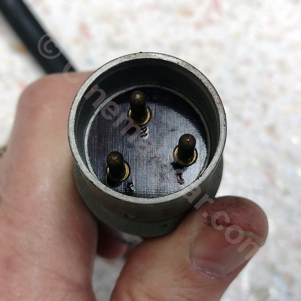 A closeup of the 3-pin power connector for the Mitchell 110V synchronous motor.