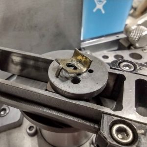 Repairing the locking tab that keeping the pull-down claw thrust washer in place on the Fries Ultra 70 3x65 IMAX-format camera
