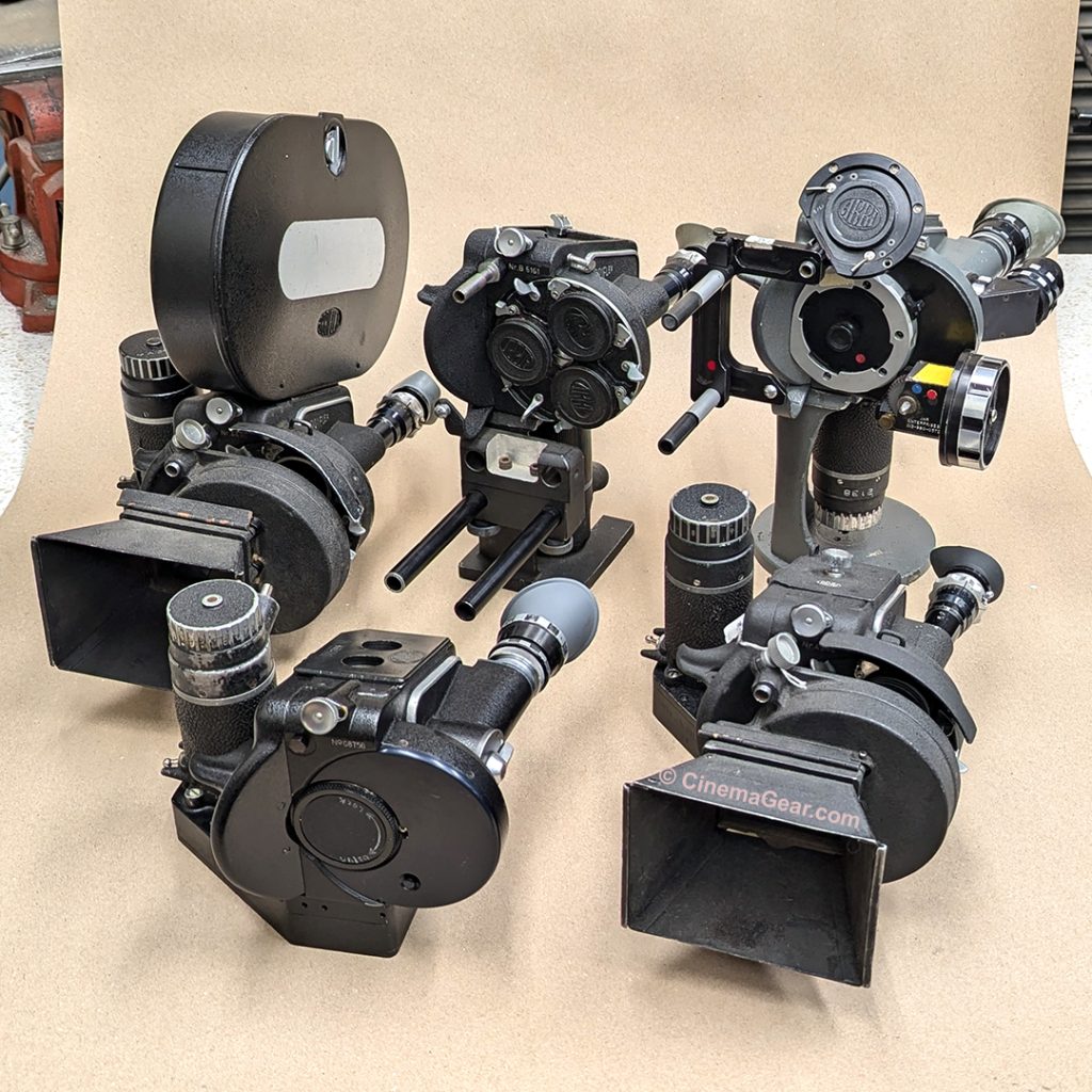 a group of five 35mm Arriflex II B and II C cameras on a table