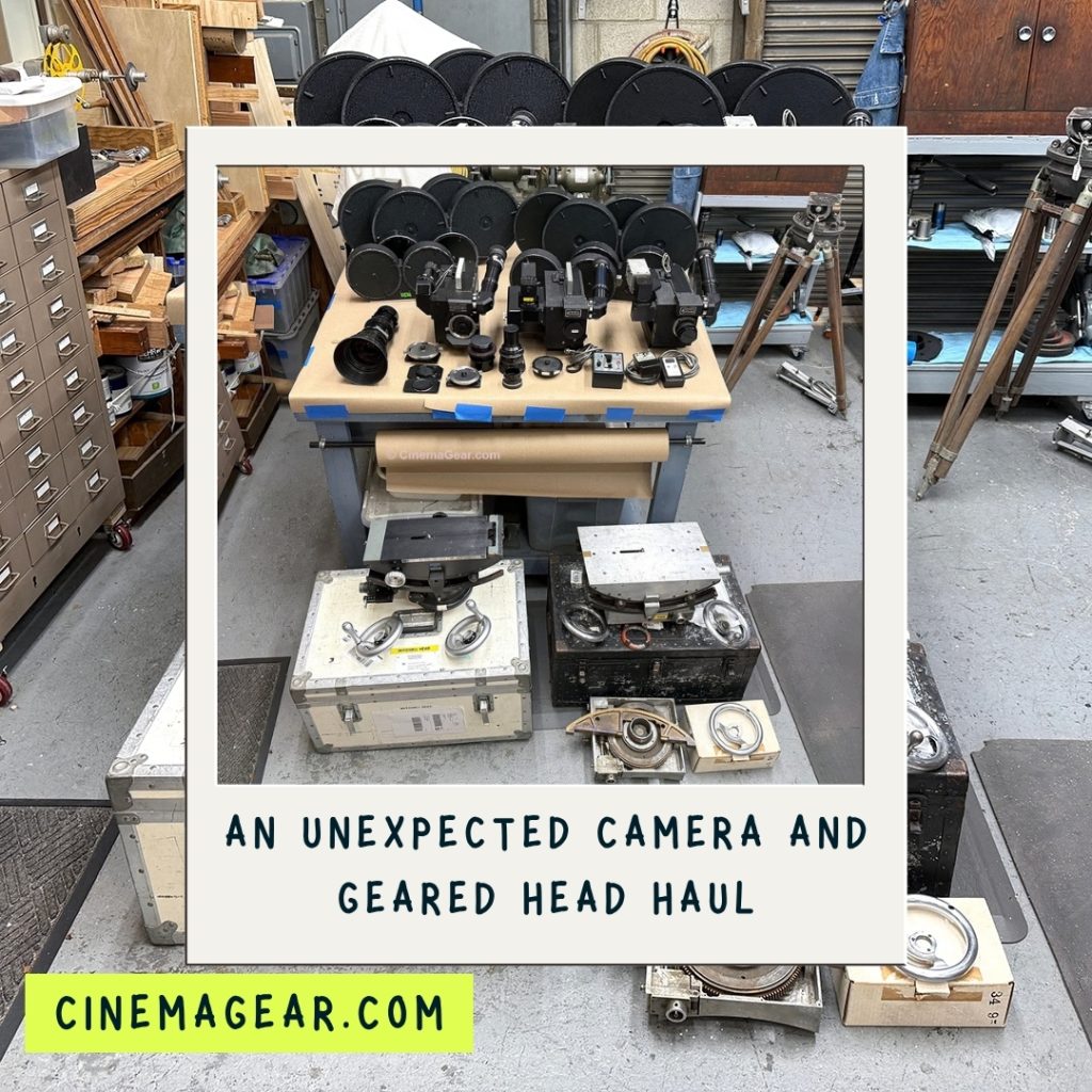 A work table with three Fries Mitchell cameras, three lenses, and eight magazines laid out on the surface, and below a Mitchell Geared Head and a Worrall Geared Head sitting on top of their respective shipping cases